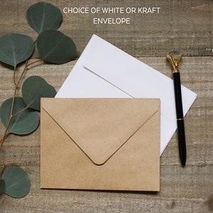 May include: A brown kraft envelope and a white envelope with a black pen on a wooden surface. The text "Choice of white or kraft envelope" is at the top of the image. The text "... Pen not included..." is at the top right of the image.