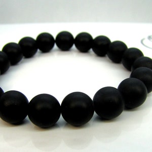 May include: A black beaded bracelet with round, matte black beads.