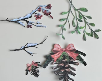 May include: Assortment of paper Christmas decorations, including a pine cone with a red bow, a snowy branch, a mistletoe sprig, and a branch with red berries.