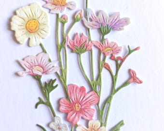May include: A paper floral arrangement featuring a variety of flowers in shades of pink, peach, and white. The flowers have detailed petals and yellow centers, with green stems and leaves. The arrangement is likely for crafting or scrapbooking.