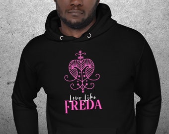 May include: A black hoodie with a pink graphic design of a heart with a floral stem and the text "Love like Freda".