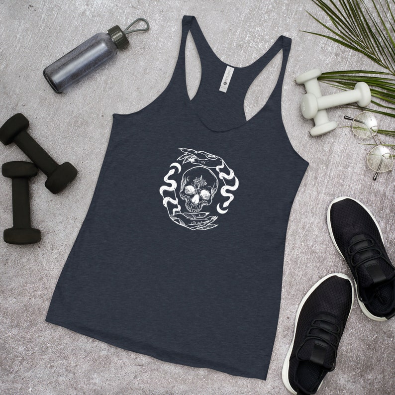 May include: A navy blue racerback tank top with a white graphic of a skull surrounded by snakes and hands.