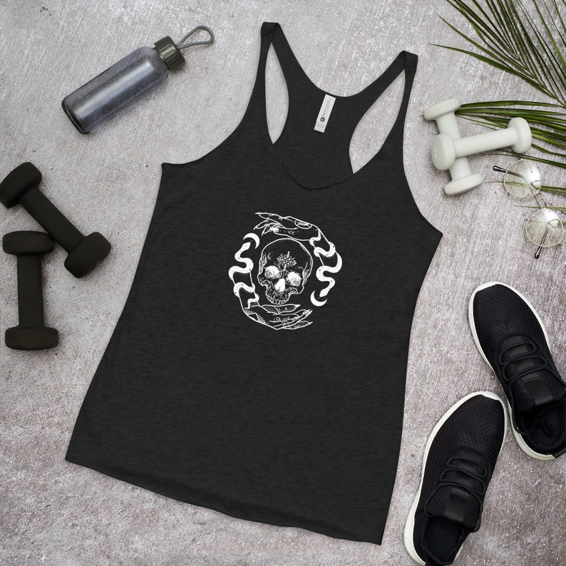 May include: Black racerback tank top with a white graphic of a skull surrounded by snakes and hands.