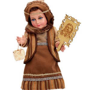May include: A brown and gold doll dressed in a traditional outfit with a woven basket and a wooden plaque with a carved image of a person.
