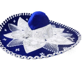 May include: A blue sombrero with white and silver embroidered details. The hat features a rounded crown and a wide, circular brim. The brim is decorated with white floral patterns and a silver trim. The hat is a traditional Mexican style.