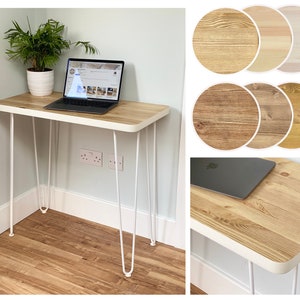 May include: White metal hairpin legs support a light wood desktop with a white edge. The desk is 75 cm wide and 45 cm deep. A laptop computer is on the desktop.