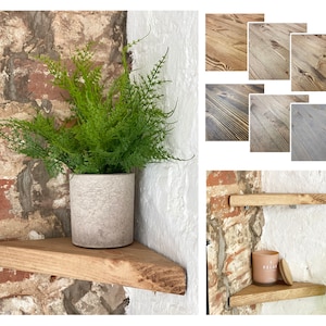 May include: Two wooden corner shelves with a plant in a gray pot on the top shelf. The shelves are mounted on a brick wall. The bottom shelf has a candle and a small wooden coaster on it.