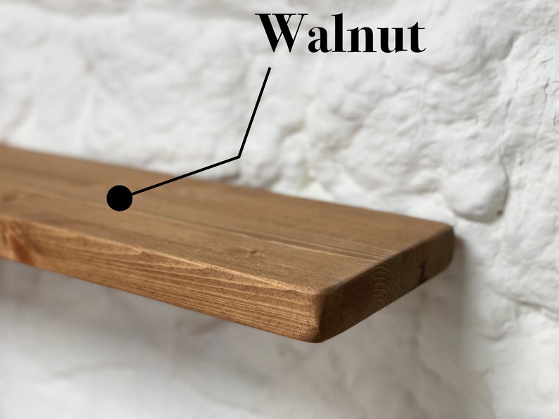 May include: A close-up of a wooden shelf with a natural walnut finish. The shelf is made of solid wood and has a smooth, polished surface.