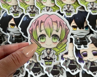 May include: A close-up of a sticker featuring a cartoon character with pink and green hair, wearing a white and green outfit. The sticker is surrounded by other stickers of different characters.
