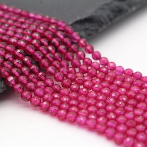 Op de afbeelding: Een streng roze facetgeslepen edelsteen kralen. De kralen zijn rond en hebben een gladde, gepolijste afwerking.