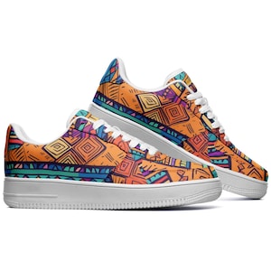 May include: A pair of white sneakers with a colorful geometric pattern. The pattern features orange, blue, green, and purple colors.