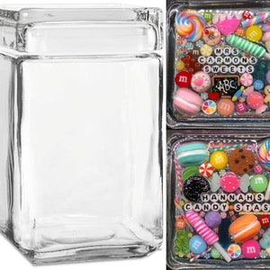May include: Two square glass jars with lids. The jar on the left is empty. The jar on the right is filled with colorful candy, sprinkles, and other decorations. The text on the jar reads "MRS CARMONS SWEETS" and "HANNAHS CANDY STAS".