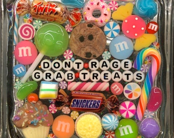 May include: A clear square resin tray filled with colorful candy, sprinkles, and other sweet treats. The tray has the words "Don't Rage Grab Treats" spelled out in white letters.