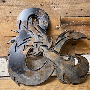 May include: A wooden D20 dice with a dragon design, painted in a distressed black and brown finish.