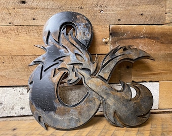 May include: A wooden D20 dice with a dragon design, painted in a distressed black and brown finish.