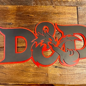 May include: A black and red wooden sign with the letters "D&D" and a dragon design.