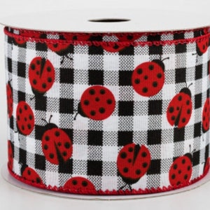 May include: A roll of white and black buffalo plaid ribbon with red ladybugs printed on it.