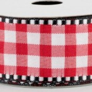 May include: Red and white gingham ribbon with a black and white trim. The ribbon is rolled up on a spool.
