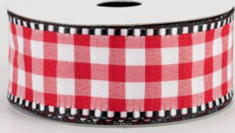 May include: Red and white gingham ribbon with a black and white trim. The ribbon is rolled up on a spool.
