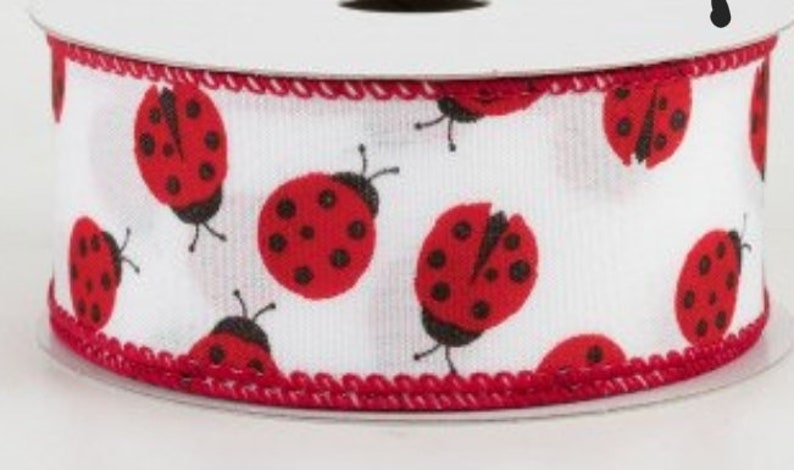 May include: White ribbon with a red trim and a repeating pattern of red ladybugs with black spots.