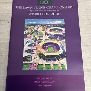 May include: A purple program for the Wimbledon 2000 Lawn Tennis Championships. The cover displays an illustration of the tennis courts and stadium. Text includes "The Championships Wimbledon 2000" and "26th June-9th July".
