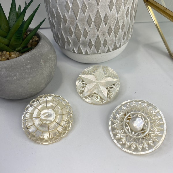 Carved mother of pearl Jerusalem brooches. Each sold separately.