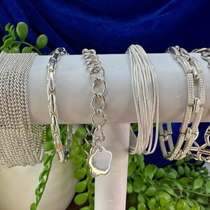 Silver coloured fashion bracelets. Each sold separately.