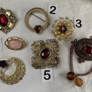 Assorted vintage brooches. Each sold separately.