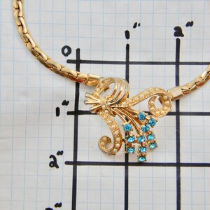 Vintage gold coloured necklace with synthetic pearl and rhinestone accents. image 5