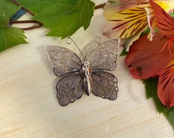 Delicate vintage silver coloured butterfly brooch