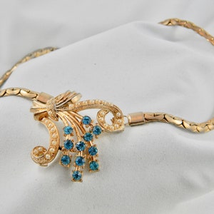 Vintage gold coloured necklace with synthetic pearl and rhinestone accents. image 1
