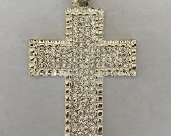 Large white rhinestone cross pendant.