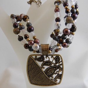 Vintage Coldwater Creek multi strand beaded necklace with large square bronze coloured pendant