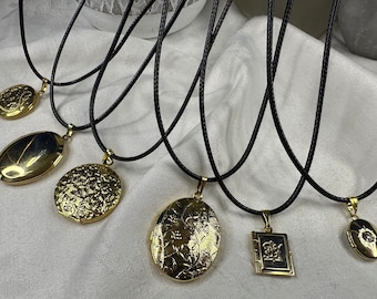 Assorted fashion pendants on black cord necklaces. Each sold separately.