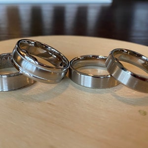 Unisex silver coloured metal fashion ring bands. Size 10. Each sold separately.