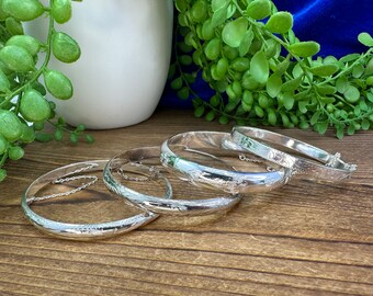 Assorted silver 925 hinged bangle bracelets with safety chains. Each sold separately.