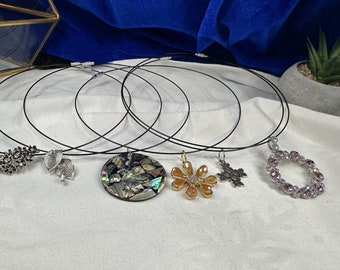Assorted fashion pendants on stainless steal black necklaces. Each sold separately.