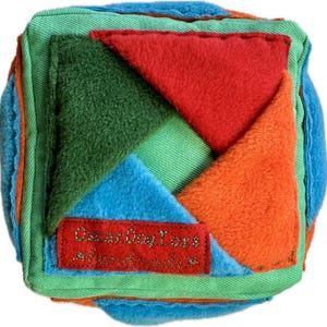 Snuffle developmental cube with 24 pockets. Size 5.5/5.5 inches (14 cm/14 cm)