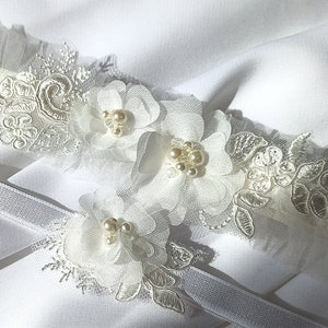 Beautiful details of bridal garter. Laser cut chiffon and tulle flowers with glass pearls and beads.