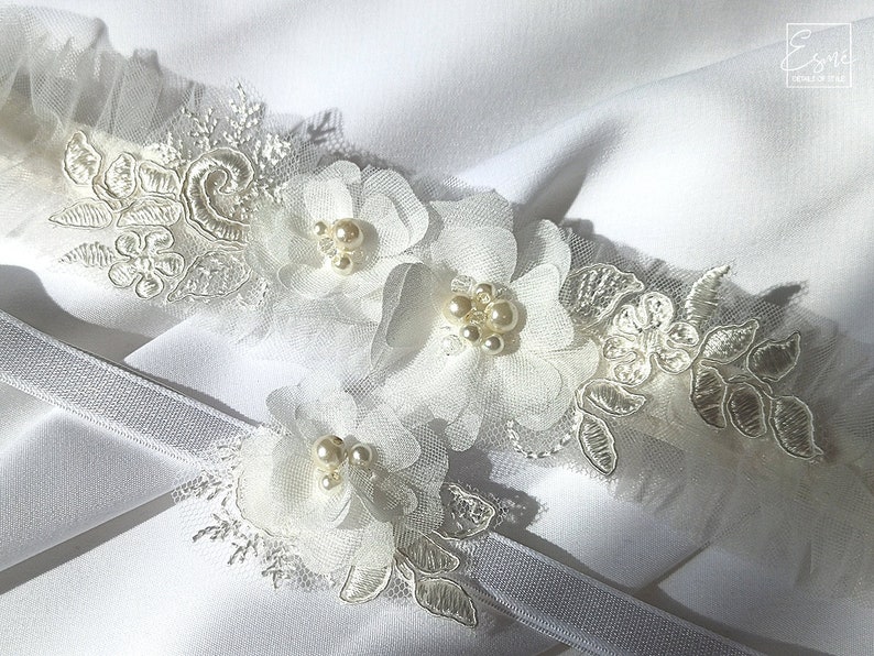 Beautiful details of bridal garter. Laser cut chiffon and tulle flowers with glass pearls and beads.