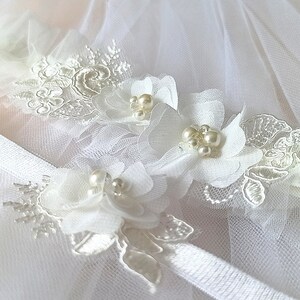 Beautiful details of bridal garter. Laser cut chiffon and tulle flowers with glass pearls and beads.
