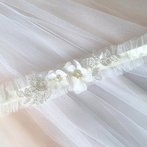 Handmade wedding garter made of tulle, lace and flowers.