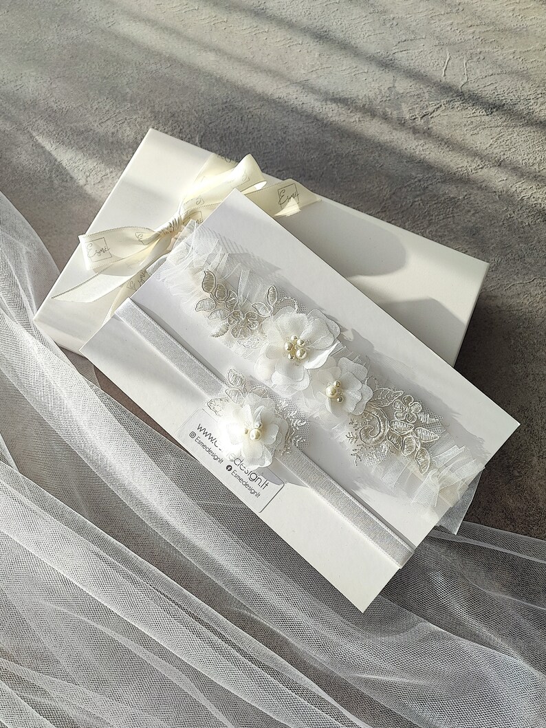 White wedding garter with lace and fabric flowers. Handcrafted with glass pearls and beads. Ready to gift, packed in white box.