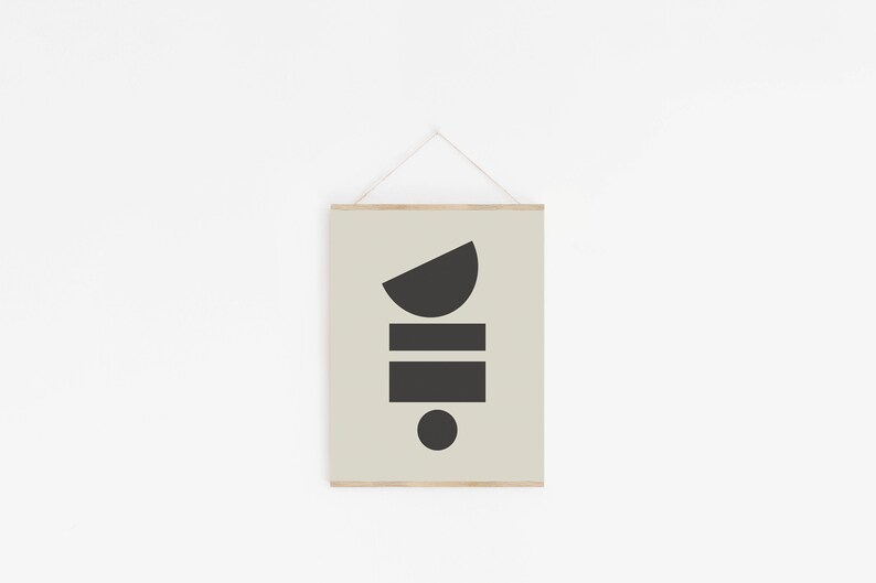 May include: A framed print with a minimalist geometric design. The print features a black half-circle, two black rectangles, and a black circle on a light green background.