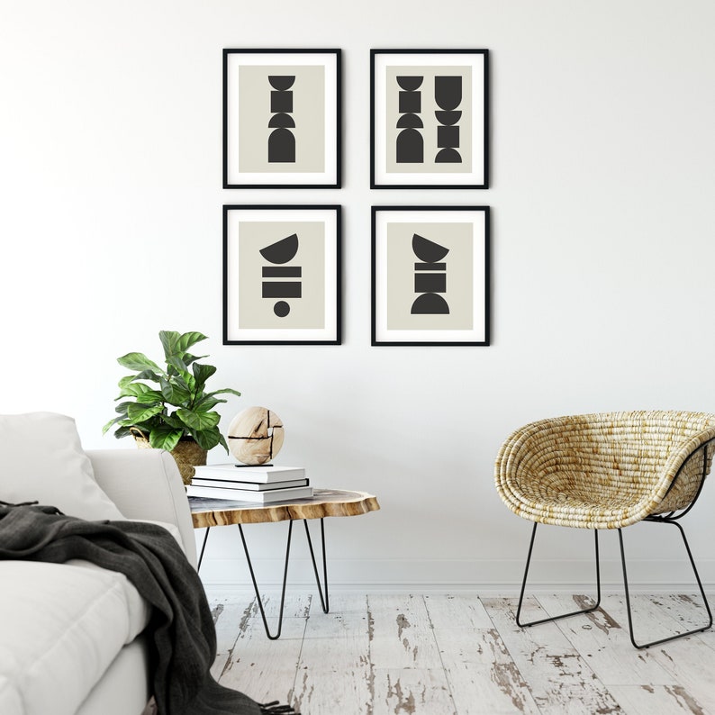 May include: Four black and white abstract geometric prints in black frames on a white wall. The prints feature different combinations of circles, semi-circles, and rectangles.