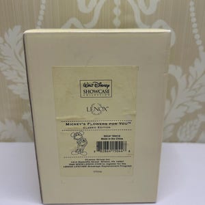 May include: A beige box featuring the text "MICKEY'S FLOWERS FOR YOU" and a cartoon image of Mickey Mouse. The box also has the "Walt Disney Showcase Collection" logo and the brand name "LENOX".
