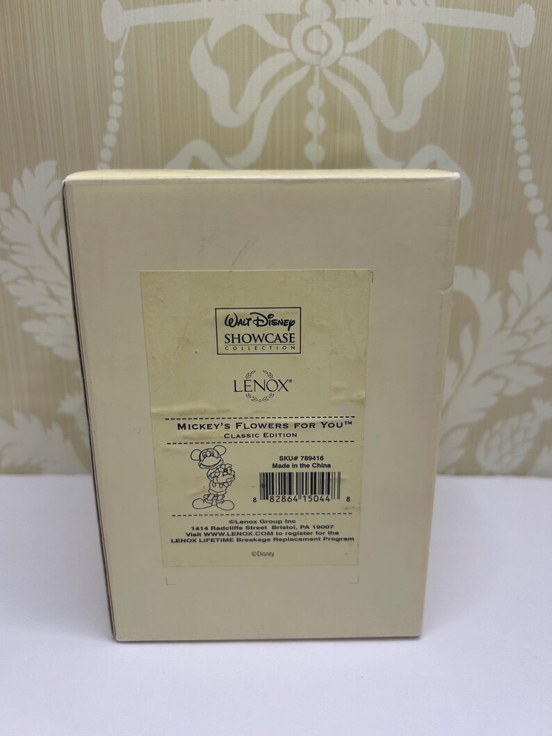 May include: A beige box featuring the text "MICKEY'S FLOWERS FOR YOU" and a cartoon image of Mickey Mouse. The box also has the "Walt Disney Showcase Collection" logo and the brand name "LENOX".