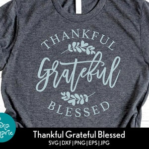 May include: A gray t-shirt with a blue design that says "Thankful Grateful Blessed".