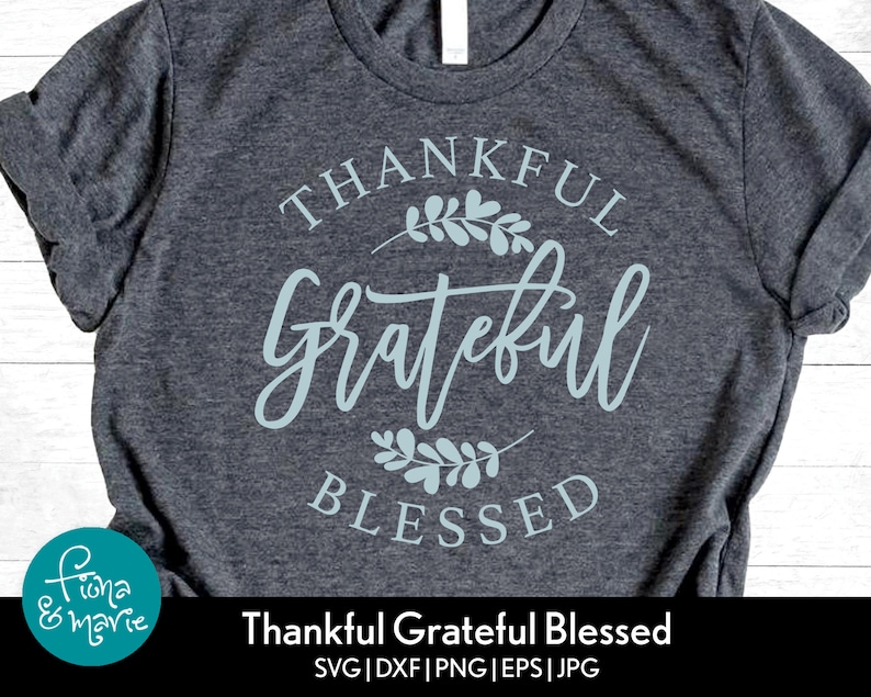 May include: A gray t-shirt with a blue design that says "Thankful Grateful Blessed".