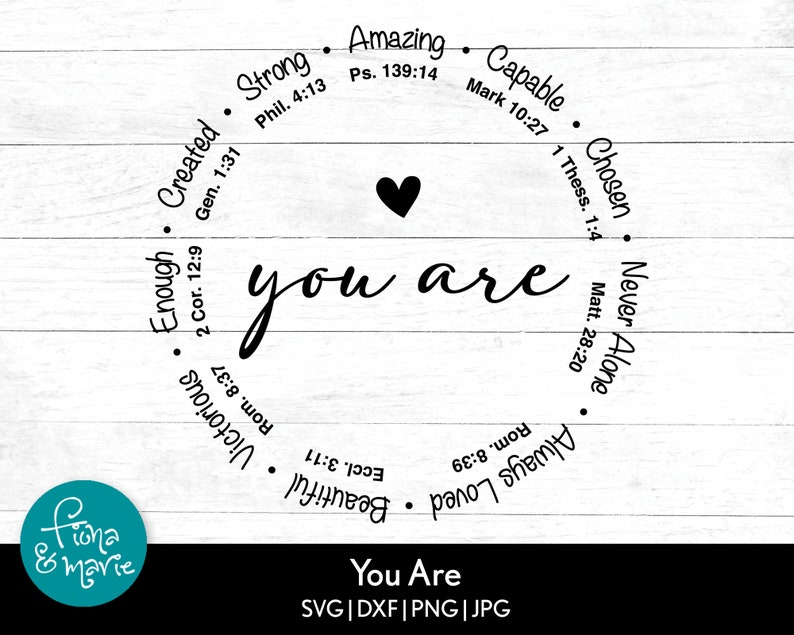 May include: A white wood background with a black circle containing the words "You Are" in a cursive font. The circle is surrounded by a ring of words and bible verses, including "Strong", "Amazing", "Capable", "Chosen", "Never Alone", "Always Loved", "Beautiful", "Victorious", "Enough", "Created".